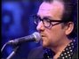 Paroles de Why can't a man stand alone? Elvis Costello